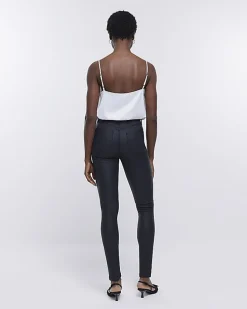 Black coated denim high waisted skinny jeans