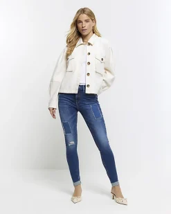 Blue mid rise bum sculpt patch skinny jeans