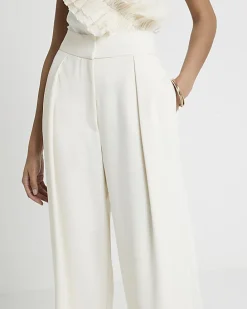 Cream pleated wide leg trousers