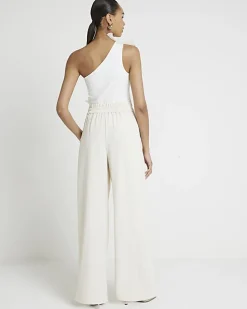 Cream pleated wide leg trousers