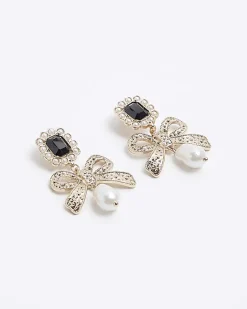 Gold pearl bow drop earrings