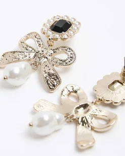 Gold pearl bow drop earrings